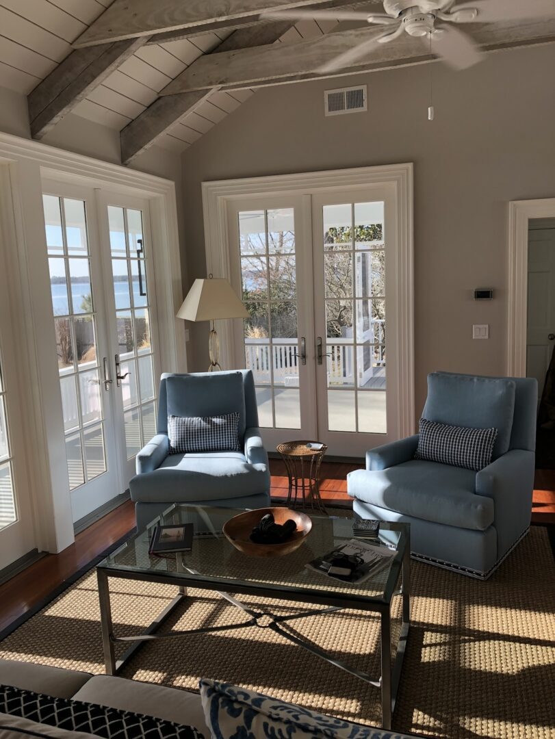 A living room with two chairs and a table