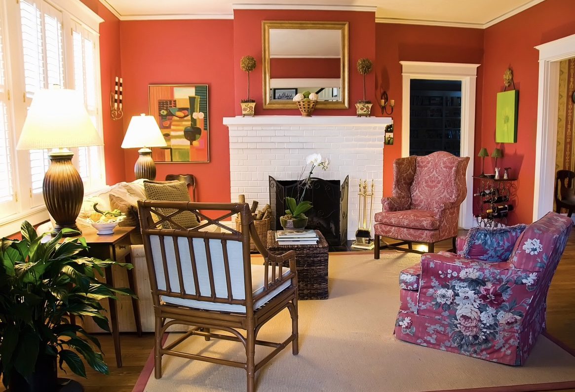 A living room with red walls and furniture.