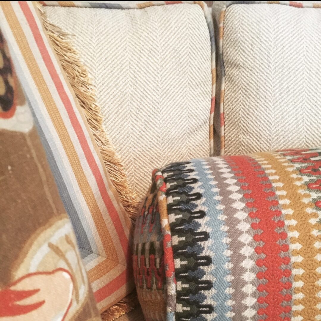 A close up of the pillows on a couch