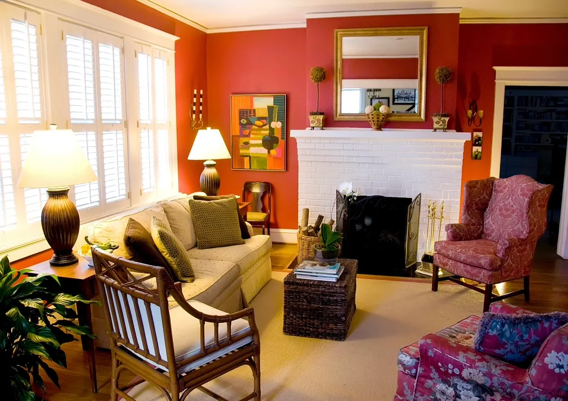 A living room with red walls and furniture.